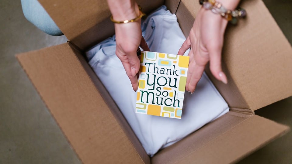 Hands Packing Dropshipping Product With Thank You Card
