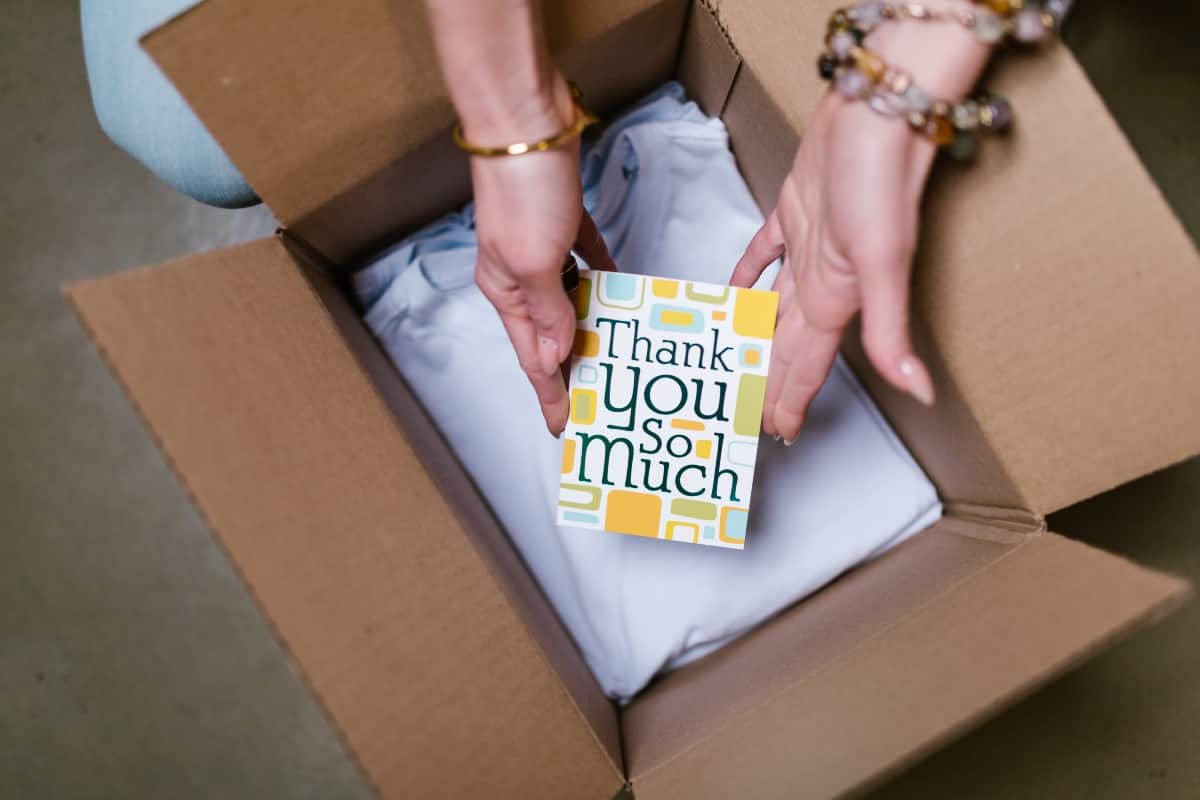 Hands Packing Dropshipping Product With Thank You Card